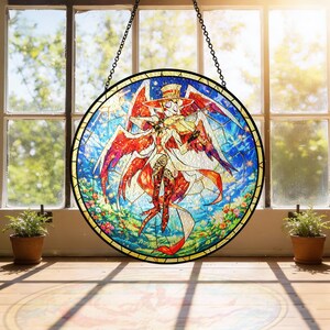 May include: A round stained glass window featuring a colorful anime-style character with red wings, a hat, and a white coat. The artwork is set against a blue sky with stars and flowers, framed by a black metal border and hanging from a chain.