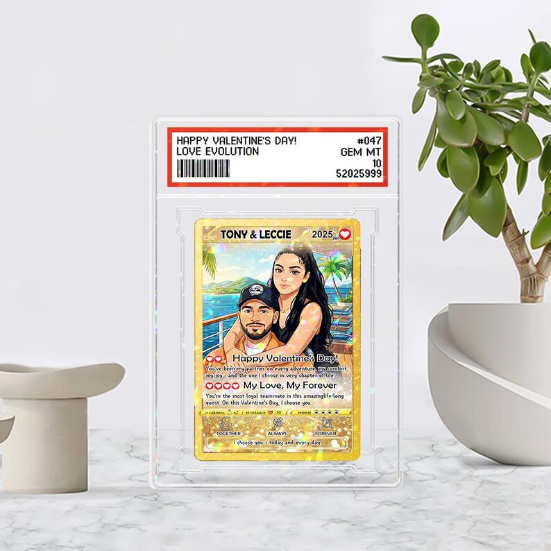 May include: A custom Valentine's Day card featuring a couple, with the text "Happy Valentine's Day!" and "My Love, My Forever." The card is encased in a clear protective holder. The card has a gold background and a tropical beach scene.