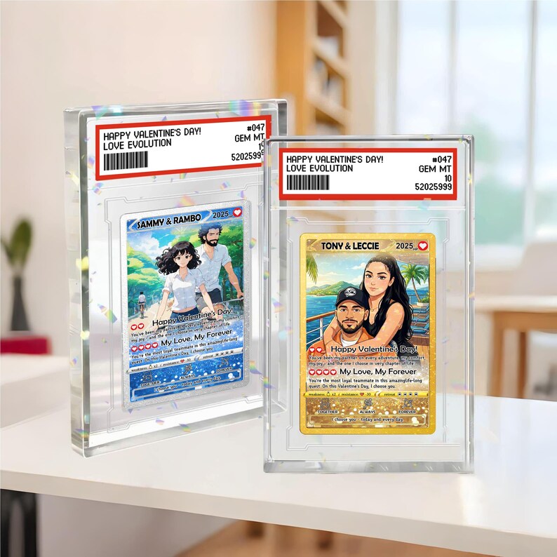 May include: Two clear acrylic cases displaying Valentine's Day cards. The cards feature couples with the text "Happy Valentine's Day!" and "My Love, My Forever." One card is labeled "SAMMY & RAMBO 2025," the other "TONY & LECCIE 2025."