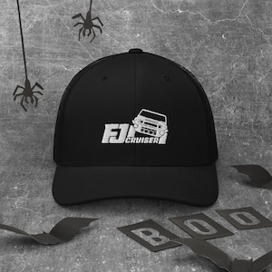 May include: Black trucker hat with a white embroidered logo of a car with the text "FJ Cruiser" on it.