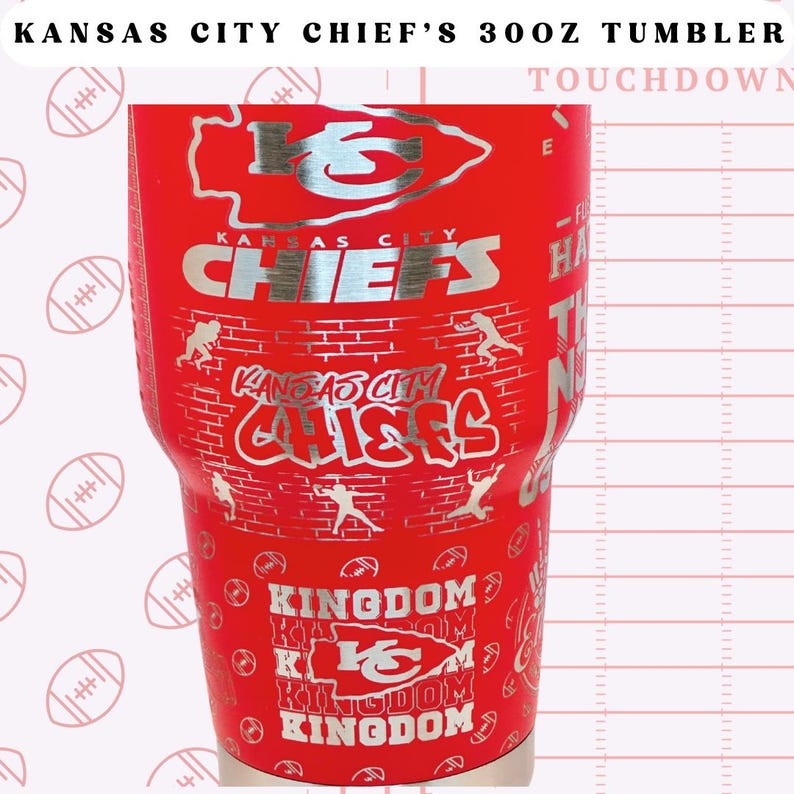 May include: Red stainless steel tumbler with a silver Kansas City Chiefs logo and the words "KANSAS CITY CHIEF'S 300Z TUMBLER" and "TOUCHDOWN".
