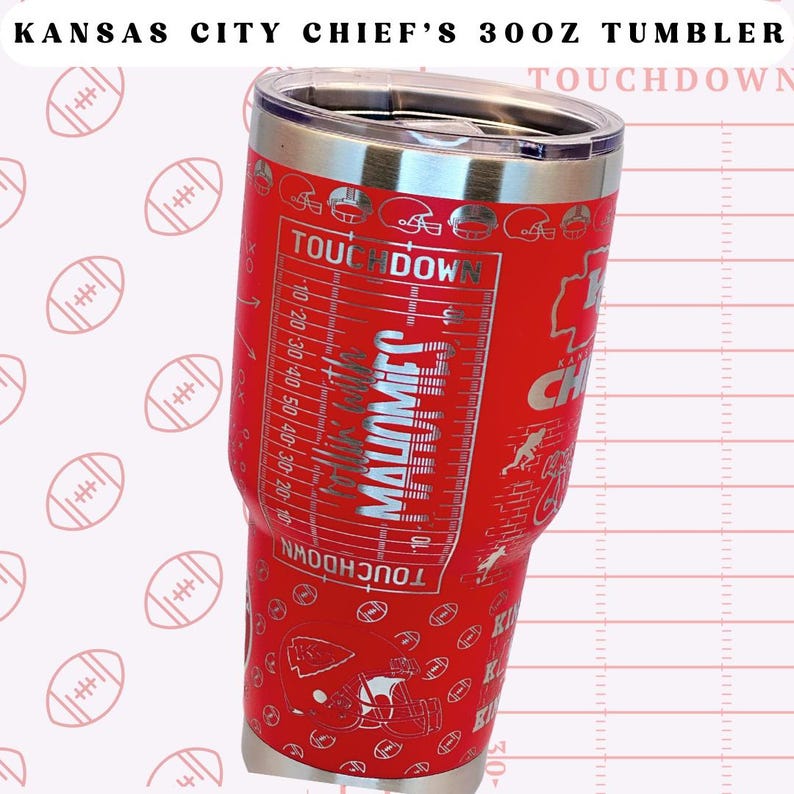 May include: Red stainless steel tumbler featuring a Kansas City Chiefs logo and the words "TOUCHDOWN" and "MAHOMES".