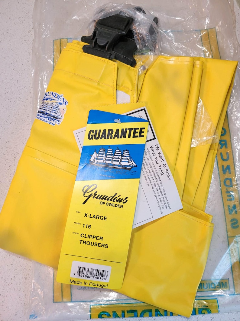May include: Bright yellow Grund&eacute;ns Clipper Trousers, size X-Large, with black suspenders, in a clear plastic bag. The trousers have a guarantee tag and a Grund&eacute;ns of Sweden label. The label also states the trousers are made in Portugal.