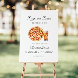May include: A white rectangular sign on a wooden easel featuring the text Pizza and Brews BEFORE I DO'S, WELCOME TO OUR Rehearsal Dinner, HANNAH + DOMINIC, and JUNE 24TH 20XX. A watercolor illustration of a pepperoni pizza and a glass of beer is centered.