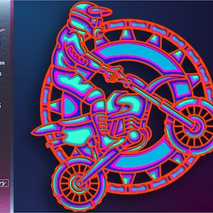 May include: A colorful, layered, paper cut design of a motocross rider on a dirt bike. The rider is wearing a helmet and goggles, and the bike has a large front wheel. The design is set against a dark blue background.
