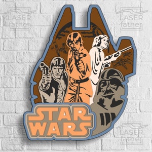 May include: A Star Wars themed wood cutout featuring Luke Skywalker, Princess Leia, Han Solo, and Darth Vader. The characters are depicted in a vintage style with a brown, orange, and blue color scheme. The text "STAR WARS" is displayed in a bold font.