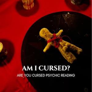 May include: A tan-colored clay effigy doll wrapped in red thread with small metal pins inserted into the body, placed on a black circular surface. The text reads AM I CURSED? ARE YOU CURSED PSYCHIC READING in white capital letters.