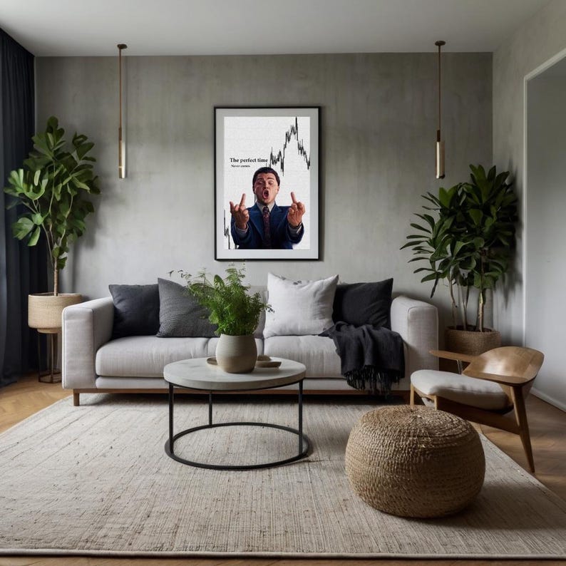 May include: A framed poster with the text "The perfect time" and a stock chart graphic. The image features a man in a suit gesturing with both hands. The poster is displayed in a modern living room setting.