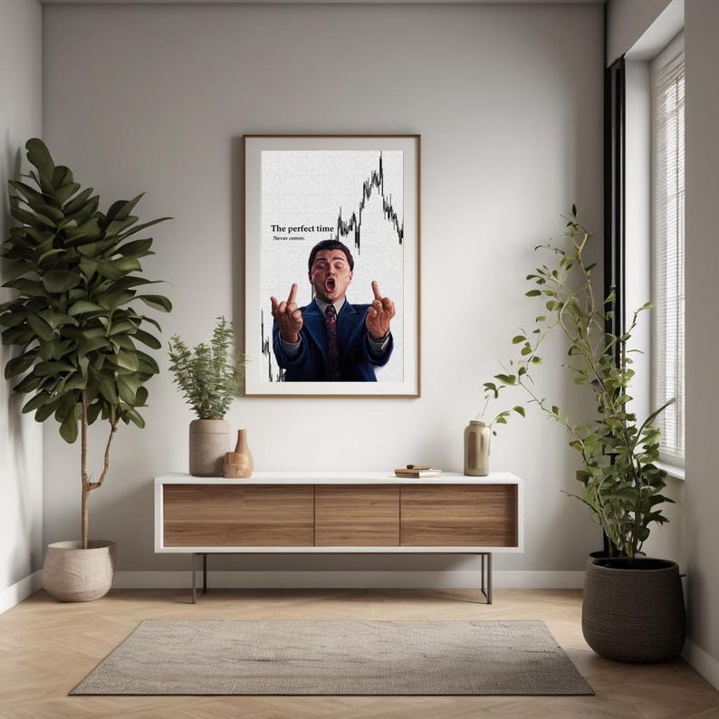 May include: Framed wall art featuring a man in a suit gesturing with both middle fingers up, with a stock chart background. The text reads "The perfect time. Never settle."