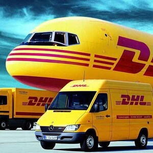 May include: A yellow DHL cargo plane with a red stripe and the DHL logo on the side. A yellow DHL delivery truck and a yellow DHL van are parked in front of the plane.