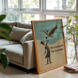 May include: A framed vintage poster with the text "My Goodness My Guinness." The artwork shows a man in a top hat reaching for a pint of stout, with a bird flying above. The frame is made of wood.