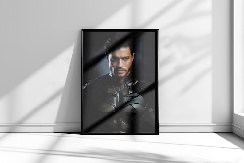 May include: A framed black and white portrait of a man with dark hair and a serious expression. He is wearing a dark suit and tie. The background is a dark, blurry image.