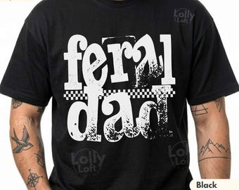 May include: Black t-shirt with the words "feral dad" in large white distressed lettering. The text is separated by a black and white checkered pattern. The shirt is made of a soft material.