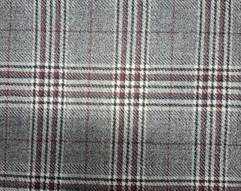 May include: Close-up of a gray plaid fabric with a repeating pattern of intersecting lines. The pattern includes dark gray, burgundy, and white lines, creating a grid-like design. The fabric has a textured appearance.