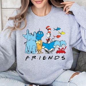 May include: Gray sweatshirt with a graphic of characters from the book "The Cat in the Hat" and the word "FRIENDS" printed below.