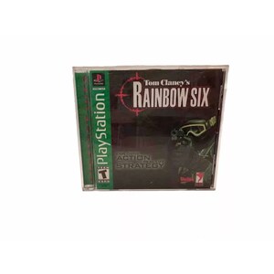May include: A PlayStation game case for Tom Clancy's Rainbow Six. The case is green and black with a picture of a soldier wearing a gas mask and holding a gun. The text "Tom Clancy's Rainbow Six" is in white letters on a red background. The text "Explosive Action Real-Life Strategy" is in white letters on a black background.