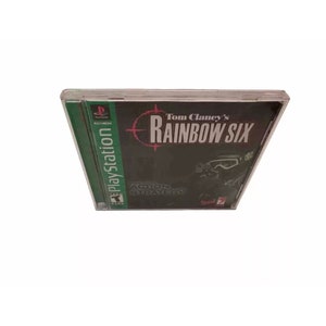 May include: A PlayStation game case for Tom Clancy's Rainbow Six. The case is black with a red and white target graphic and the game title in white text. The game is rated Teen by the ESRB.