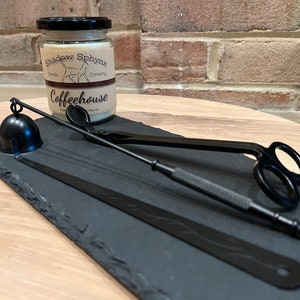 May include: A black slate tray with a candle snuffer, wick trimmer, and candle tongs. The candle jar is labelled "Shadow Sphinx Candle Company" and "Coffeehouse".