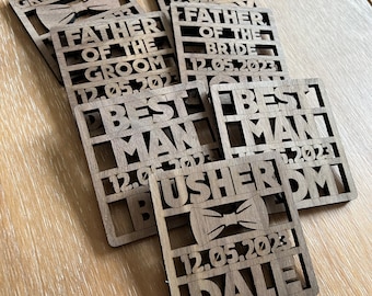 May include: Wooden coasters with different titles for a wedding party, including "Groom", "Best Man", "Usher", "Father of the Bride", and "Step Dad of the Groom". Each coaster has a bowtie design and the date "12.05.2023".