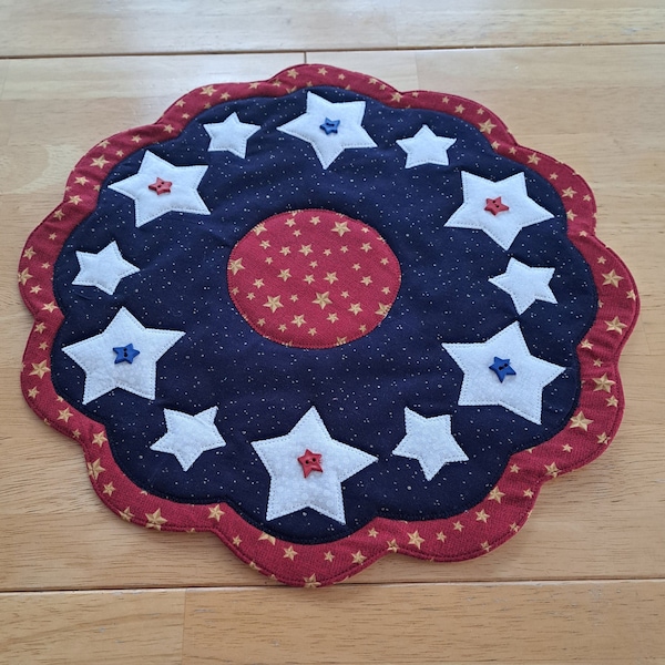 Patriotic table topper/candle mat, quilted.  Round with scalloped edges, hand made.  14 inch diameter.  Quilted, Applique and Hand Made.