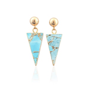 May include: A pair of gold-colored earrings. Each earring features a gold ball stud, a gold connecting loop, and a turquoise triangle pendant with gold-colored veining. The earrings are displayed against a white background.