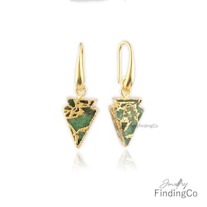 May include: Gold earrings with a green and gold triangular pendant. The pendant is made of a green stone with gold accents.