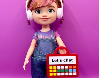 Dispositivo de comunicación aumentativa y alternativa (CAA) acrílico del tamaño de una muñeca con asa para exhibición, decoración y para representar diversos modos de comunicación y apoyar la inclusión.