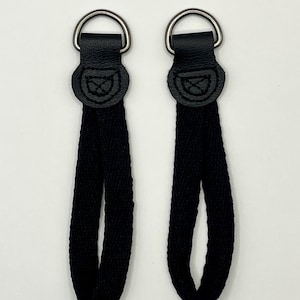 Unique attachment interface for carry strap and iPad case or AAC device, for cases which don’t suit direct connection via swivel clips etc.