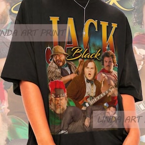 May include: Black t-shirt with a graphic print of a group of people with the text "Jack Black" on the front.
