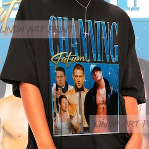 May include: Black t-shirt featuring a collage of images of Channing Tatum with the text "CHANNING TATUM" in a blue and gold design. The model is wearing sunglasses and a silver necklace.