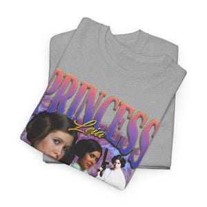 May include: Gray t-shirt with a graphic print of Princess Leia in a retro style. The text "Princess Leia" is in a colorful, stylized font.