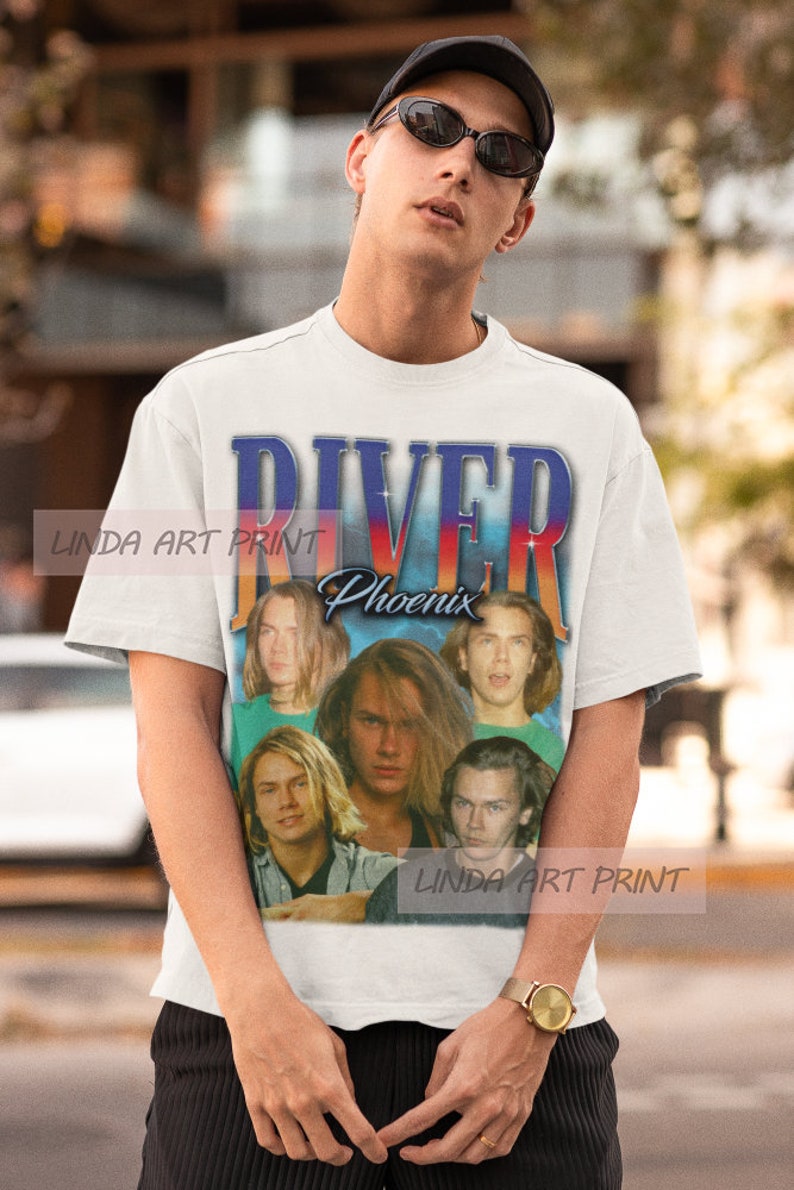 May include: White t-shirt with a vintage-style graphic of the band "River Phoenix". The graphic features a collage of photos of the band members.