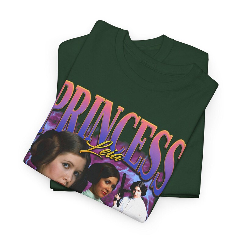 May include: A dark green t-shirt with a graphic print of Princess Leia from Star Wars. The graphic features a pink, purple, and blue gradient with the text "Princess Leia" in a yellow outline.