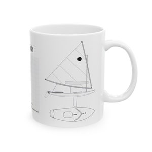 May include: White ceramic mug with a black and white line drawing of a sailboat. The text "Sunfish" is printed on the mug.