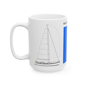 May include: White ceramic mug featuring a black line drawing of a sailboat. The mug has a large handle and a blue vertical stripe with the word "Hallberg" printed on it. The design is simple and nautical.