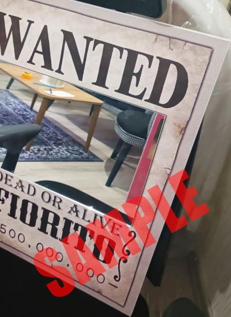 K&ouml;nnte beinhalten: Ein rechteckiges Poster mit einem Steckbrief im Vintage-Stil mit dem Text WANTED, DEAD OR ALIVE, FIORITO und 500.000.000. Das Design hat ein gealtertes Papier-Aussehen mit einem gro&szlig;en, roten, durchscheinenden SAMPLE-Wasserzeichen in der Mitte.