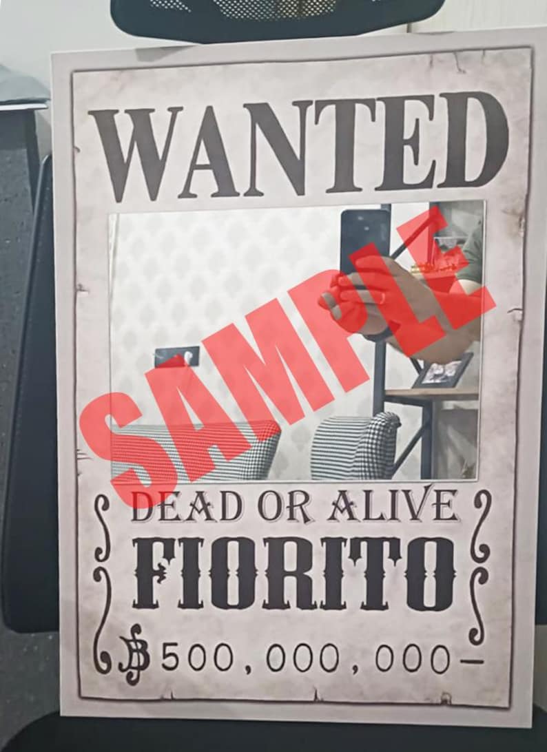 K&ouml;nnte beinhalten: Ein rechteckiges Poster mit einem Steckbrief im Vintage-Stil mit dem Text WANTED, DEAD OR ALIVE, FIORITO und 500.000.000. Die Mitte enth&auml;lt eine reflektierende Spiegelfl&auml;che mit einem gro&szlig;en, durchscheinenden roten SAMPLE-Wasserzeichen.