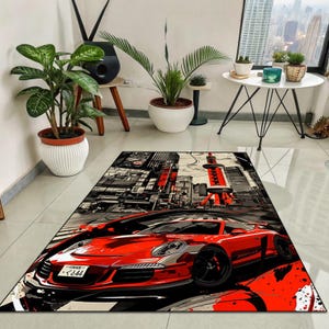 May include: A rectangular area rug featuring a red sports car in a cityscape design. The rug has a black, white, and red color scheme, with a focus on the car and a tall tower. The rug is placed on a light-colored floor.