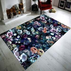 May include: A dark blue rug with a floral pattern featuring skulls and butterflies. The flowers are in shades of pink, purple, red, yellow, and white.