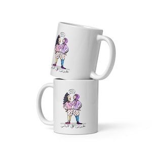 May include: Two white ceramic mugs stacked on top of each other. The mugs feature a cartoon illustration of two women wearing pajamas and the text "BFF!" in a speech bubble. The text "طربتني في الباس" is written in Arabic on both mugs.