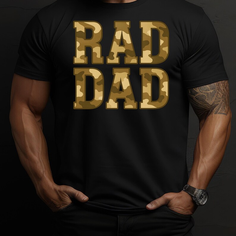 May include: Black t-shirt with the words "RAD DAD" in camouflage print. The text is in a bold, blocky font, and the camouflage pattern features shades of brown and green. The shirt is a classic crew neck style.