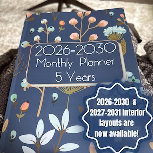 May include: A dark blue monthly planner with a floral pattern featuring light blue, peach, and white botanical illustrations. The cover text reads 2026-2030 Monthly Planner 5 Years. A starburst graphic states 2026-2030 & 2027-2031 interior layouts are now available!