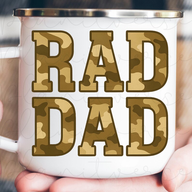 May include: White enamel mug with the words "RAD DAD" in large, bold letters. The letters have a camouflage pattern in shades of brown and tan. The mug has a silver rim and a white handle.