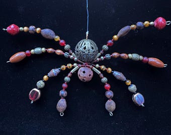 Hanging Beaded Spider Ornament: Brass, Carved Wood, and Tigers eye.