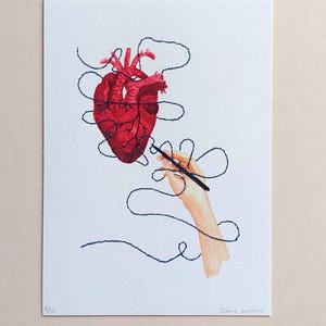 Puede incluir: Una lámina de arte rectangular sobre papel blanco con una ilustración en acuarela de un corazón anatómico rojo vibrante. Una mano sostiene una aguja con un hilo largo de color azul oscuro que se enreda alrededor del corazón. Numerada como 5/52.