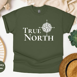 May include: A green t-shirt with a white compass and the text "TRUE NORTH" printed on the front.