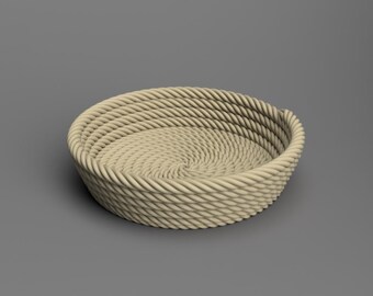 May include: A round, shallow basket constructed from thick, light beige rope coiled in a continuous spiral pattern. The rope features a twisted texture, forming the walls and base of the bowl-shaped container with a uniform, neutral color.