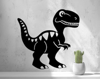 May include: A black dinosaur wall decal featuring a stylized T-Rex silhouette with white triangular markings along its back and a smiling expression, positioned next to a small green cactus in a white pot.