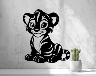 May include: A black wall decal featuring a stylized illustration of a seated tiger cub with large eyes and striped markings. The design is rendered in a bold, graphic style with smooth curves and a solid black color, showcasing a friendly expression.