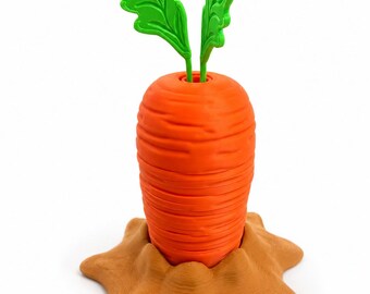 May include: An orange carrot with horizontal ridges and two bright green leafy stems protruding from the top, set into a textured, light brown, star-shaped base that resembles a mound of dirt on a plain white background.